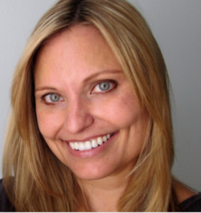 Close up picture of Christina Garner. She has blond hair, grey eyes, and is smiling.